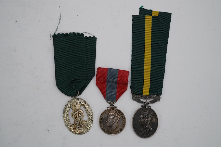 Three assorted service medals; Ed VII Volunteer Officer's Decoration hallmarked for 1905; GV Imperial Service medal to Walter Charles Cornish; GVI Territorial Efficiency medal to 2062789 . S/Sgt. L.W.Sergeant. R.A. Condi